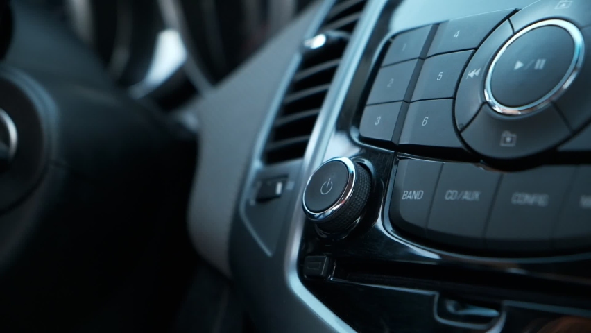 Woman hand control radio or music in car