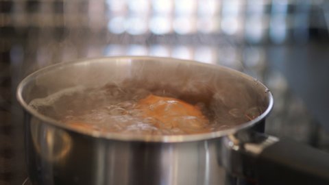 Eggs boiling in the pot in 4k slow motion 60fps
