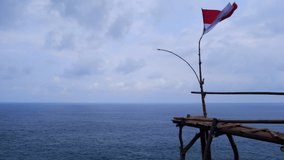 beautiful oceans view for background video. flag flying by the sea. 