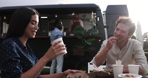 Multiracial people eating food truck gourmet meal outdoor - Healthy meal, summer and dinner concept