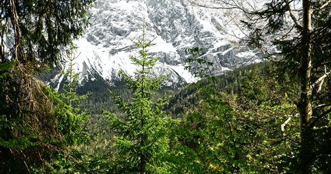 Eibsee, Bavaria Germany - May 23, 2021: View on snowy Mountain top from hiking path