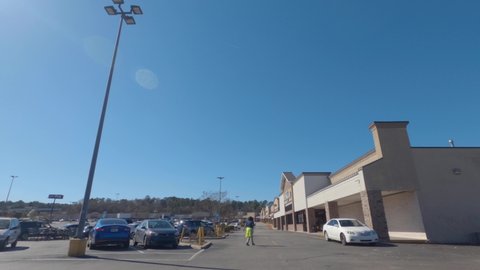 Augusta, Ga USA - 03 04 21: Time-lapse of a retail strip mall shopping center parking lot buildings and people - Windsor Spring road