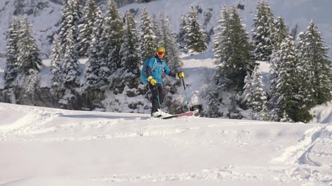 Samoens Refuge de Bostan , Haute Savoie , France - 02 15 2021: Slow motion of man skiing downhill and slaloming in snow slope