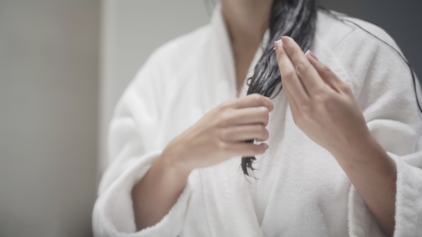 Conditioning long wet hair before a bath | Shutterstock HD Video #1074482465