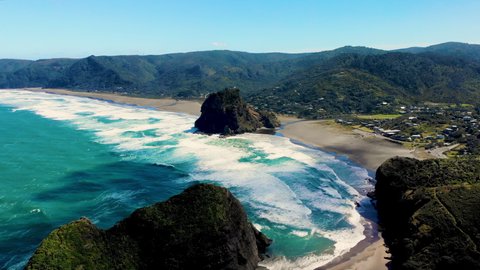 Aerial overview of beautiful and wild Piha Beach, New Zealand