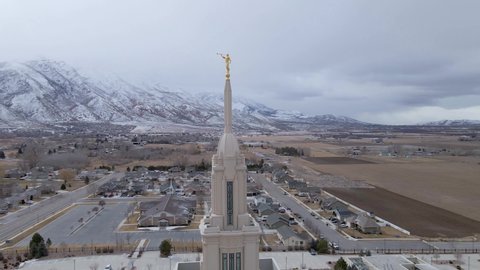 Payson , Utah , United States - 02 27 2021: Aerial shot of the spire of the Payson Utah Temple with a statue of the Angel Moroni at the top in Payson, Utah