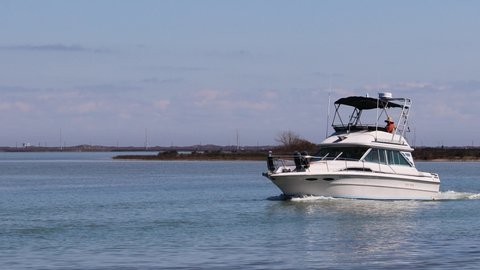 Corpus Christi , Texas , United States - 02 11 2021: Cabin Cruiser motoring along the Gulf Intercoastal Waterway