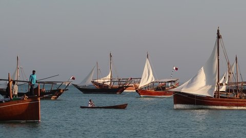 Doha , Qatar - 12 04 2020: A view of Qatari traditional wooden boat with people.