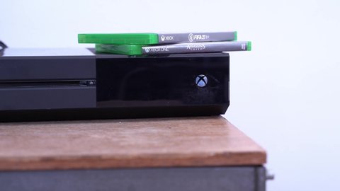 London , London , United Kingdom (UK) - 03 24 2021: Two Xbox One videogame on top of a console
