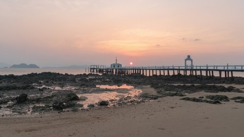 timelapse The pier jutting out into the beautiful sky at sunrise over the sea.
The water chedi of Wat Phayam in Phayam island Ranong Thailand. 
4K Videos for beautiful nature and unusual travel idea