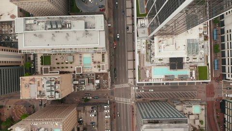 Aerial birds eye overhead top down view of wide multilane downtown streets. Vertically panning view. Dallas, Texas, US
