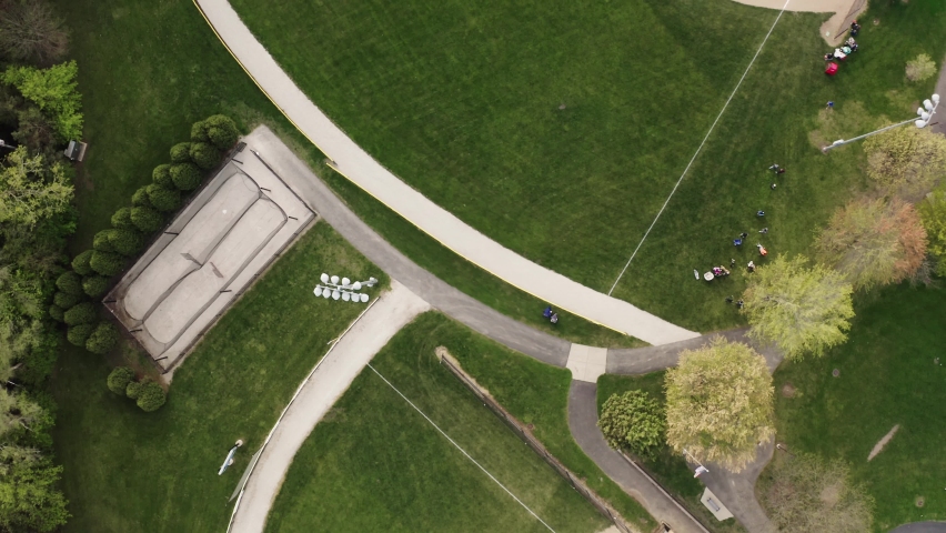 Aerial Drone view of kids play Baseball Field at Park on Sunny Day. Top view