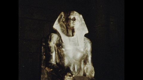 1970s: Shots of statues. Tilt down statue. View of painted sarcophagus. View of carved sarcophagus.