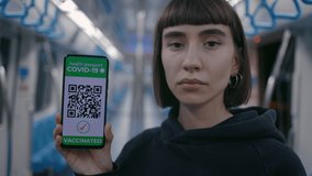 Confident female hipster with short hairstyle and piercing holding modern smartphone with health passport on screen. Young woman vaccinated from Covid-19. Immunity concept. - Powered by Shutterstock - Get 15% off with code: PIKWIZARD15