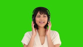 Chromakey footage of an asian woman listening to music 