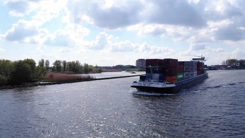 zwijndrecht , Zuid-Holland , Netherlands - 05 01 2021: Container Ship Navigates The Oude Maas River In Puttershoek. 