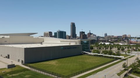 Omaha , Nebraska , United States - 06 12 2021: Drone Flies Over CHI Health Center, Reveals Downtown Omaha Skyline in Background