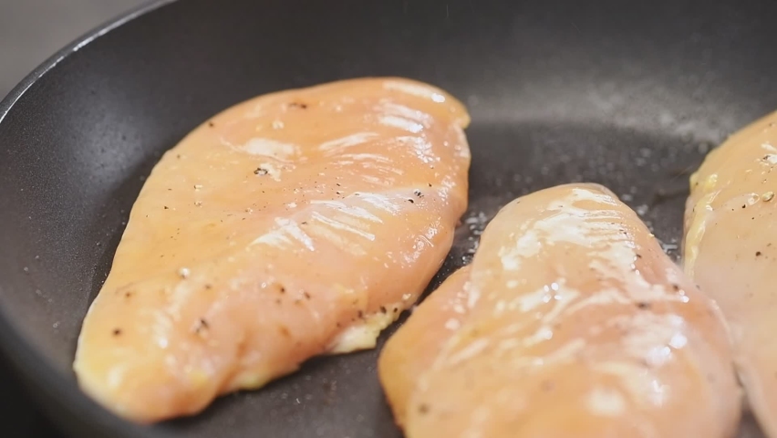 Cooking chicken breast in a frying pan. Royalty-Free Stock Footage #1074519155