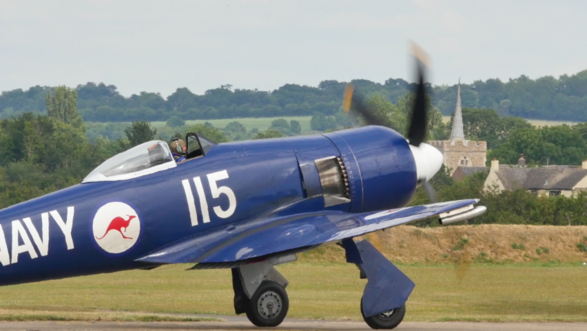 Duxford Aerodrome UK JULY, 11, 2015 Hawker Sea Fury of Royal Australian Navy with the engine running ready to enter the runway to take off. High quality 4K video for historic documentaries. 