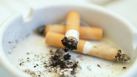 Burning Cigarette butts,tobacco waste,smoke addiction,unhealthy lifestile
