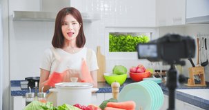 Asian pretty live streamer introduce how to cook the delicious food online with camera