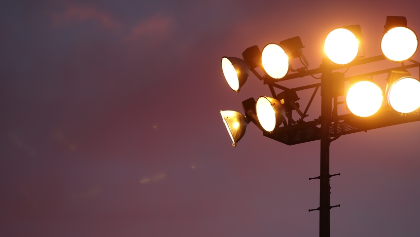 Slow Pan to Reveal Sports Lights at Sunset - Shallow Depth of Field - Slow Motion