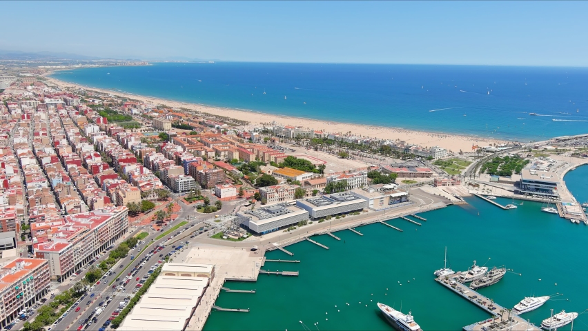 Valencia: Aerial view of famous city in Spain, city beaches (Platja del Cabanyal, Playa de la Malvarrosa and others), clear waters of Mediterranean Sea - landscape panorama of Europe from above Royalty-Free Stock Footage #1074540332