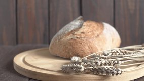 Autumn Harvest with Rye and Bread on Wooden Background. Agriculture and farming concept video.