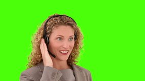 Chromakey footage of a friendly businesswoman speaking over the headset