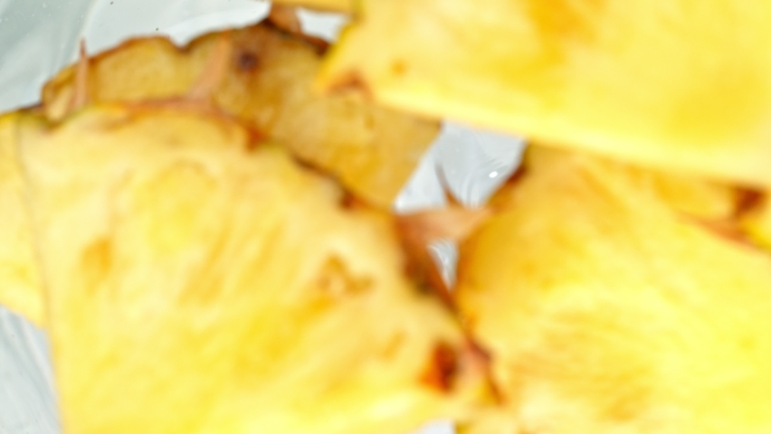 Super Slow Motion Shot of Pineapple Slices Falling Into Water Whirl at 1000 fps. Royalty-Free Stock Footage #1074559046