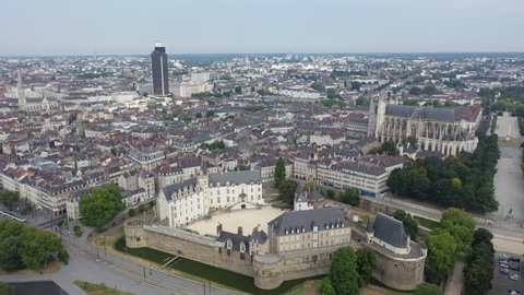 Aerial view of historic area of Nantes overlooking medieval Castle of Dukes of Brittany, Gothic Roman Catholic cathedral with Tour Bretagne on background, France