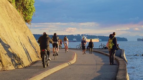 People do excercise in Seawall in sunny day, Vancouver, Canada , June 2021