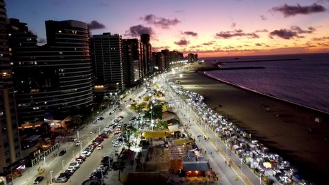 Sunset scenery of landmark of capital of state of Ceará, Brazil. Fortaleza, Ceara, Brazil. Sunset at famous coastal avenue. Brazil Northeast landmark. Sunset skyline. Sunset city. Sunrise beach.
