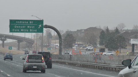 Denver , Colorado , United States - 01 10 2021: Winter Snowfall on Highway. Slow Motion of Cars Moving on Road