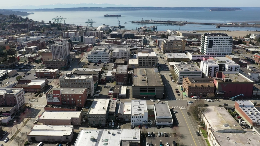 Cinematic aerial drone trucking footage of downtown Everett, Bayside, Port Gardner, Naval Station Everett suburbs, bedroom communities North of Seattle on the shores of Puget Sound in Washington
