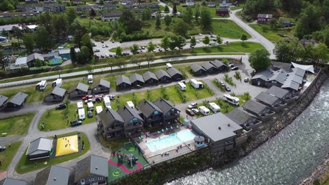 Kinsarvik , Vestland , Norway - 05 29 2021: Hardangertun Feriepark camping and Kinso salmon river - Kinsarvik Norway aerial