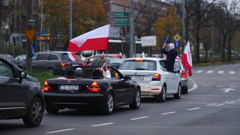 Szczecin , Poland - 11 11 2020: people waving polish flags in slow motion 