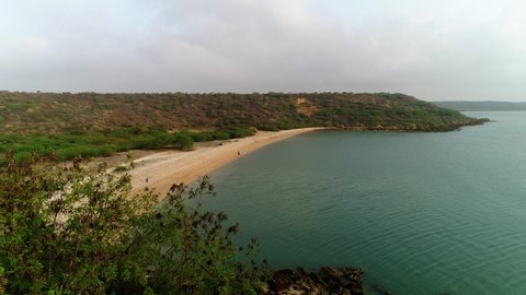 Okha , Gujarat , India - 03 31 2021: Top view of beautiful white sand beach with turquoise sea water and palm trees, aerial drone shot Redaktionell stockvideo