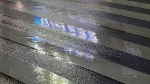 Tokyo , Japan - 01 28 2021: Car Running Over Wet Asphalt Road With Zebra Crossing