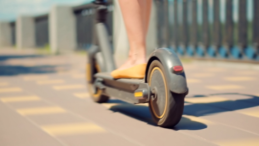 Woman Ride Electric Scooter Mobility.E-Scooter Rider Rent Eco Transport. Driving Ecology Transportation. Zero Emission Drive Electric Scooter In City. Urban Riding Ecological Scooter Transport Travel Royalty-Free Stock Footage #1074575606