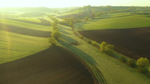 Beautiful spring morning over green hills - aerial 4k drone shot
