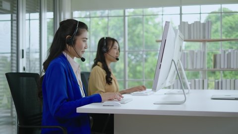 Call center asia woman Wear headphones for online video chats. Work in the office to support customers or colleagues who are far away,  telemarketing. Customer support representatives 