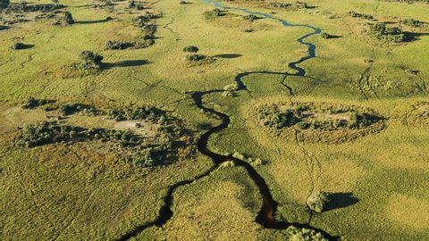 Spectacular aerial fly over view of the beautiful scenic curving patterned waterways and lagoons of the Okavango Delta