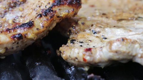 A closeup shot of sizzling meat in the griller in HD