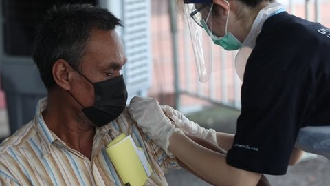 Kuala Lumpur, Malaysia - 21 JUNE 2021: A man receives a  COVID-19 vaccine during National Covid-19 Immunisation Programme .