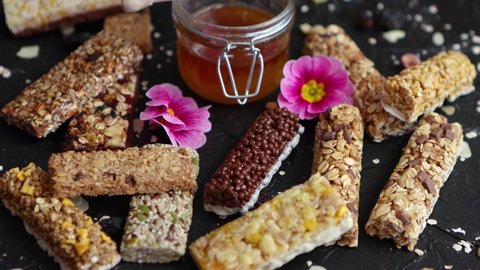 Healthy superfood composition. Various kinds granola energy protein bars with honey in jar