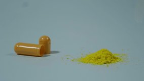Open medical capsule with yellow powder on a blue background.