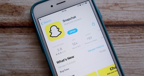Kumamoto, JAPAN - Jun 7 2021 : Man opens Snapchat app on iPhone. Snapchat is an US multimedia messaging app popular among the young gen (particularly those below age 16) by Snap Inc.