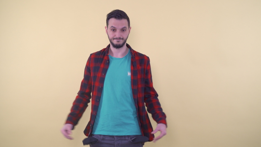 Upset man in casualclothes which showing empty pockets | Shutterstock HD Video #1074608849