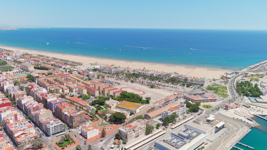 Valencia: Aerial view of famous city in Spain, city beaches (Platja del Cabanyal, Playa de la Malvarrosa and others), clear waters of Mediterranean Sea - landscape panorama of Europe from above Royalty-Free Stock Footage #1074611831
